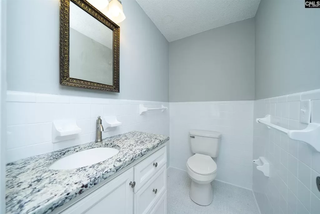 bright white bathroom showing toilet and vanity
